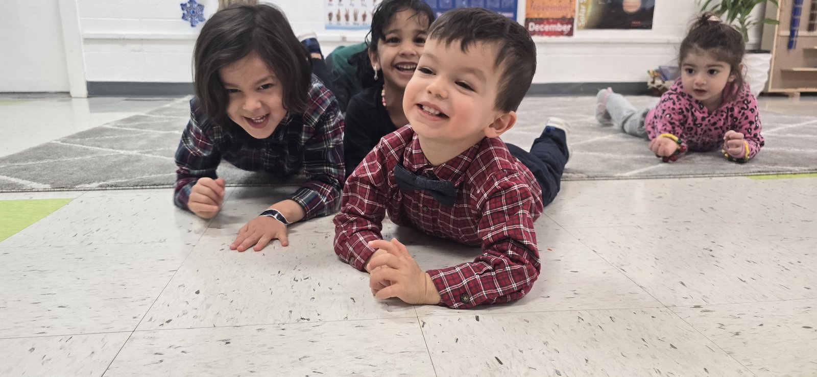Four joyful children smiling together at Milestones