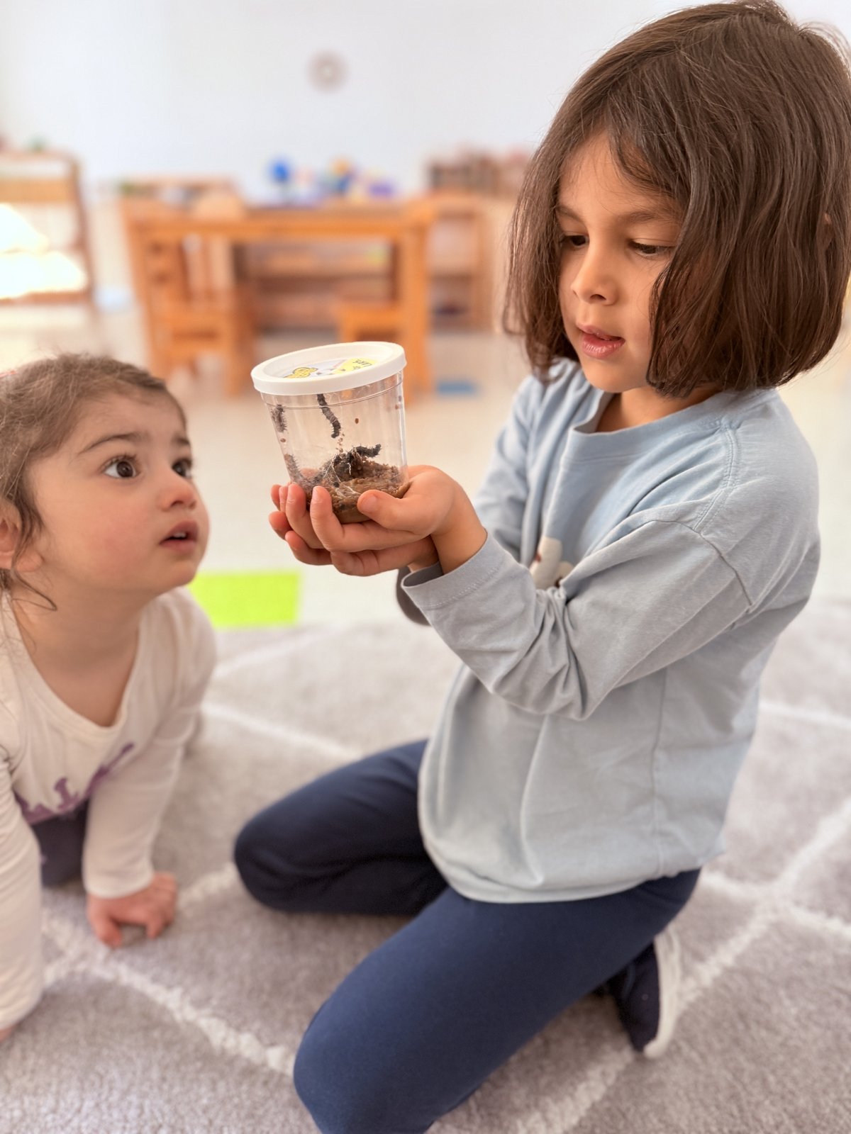Children fascinated by insects during science exploration