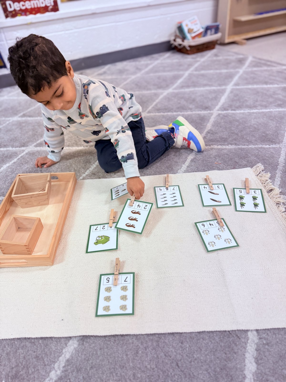 Child focused on threading and lacing fine motor activity