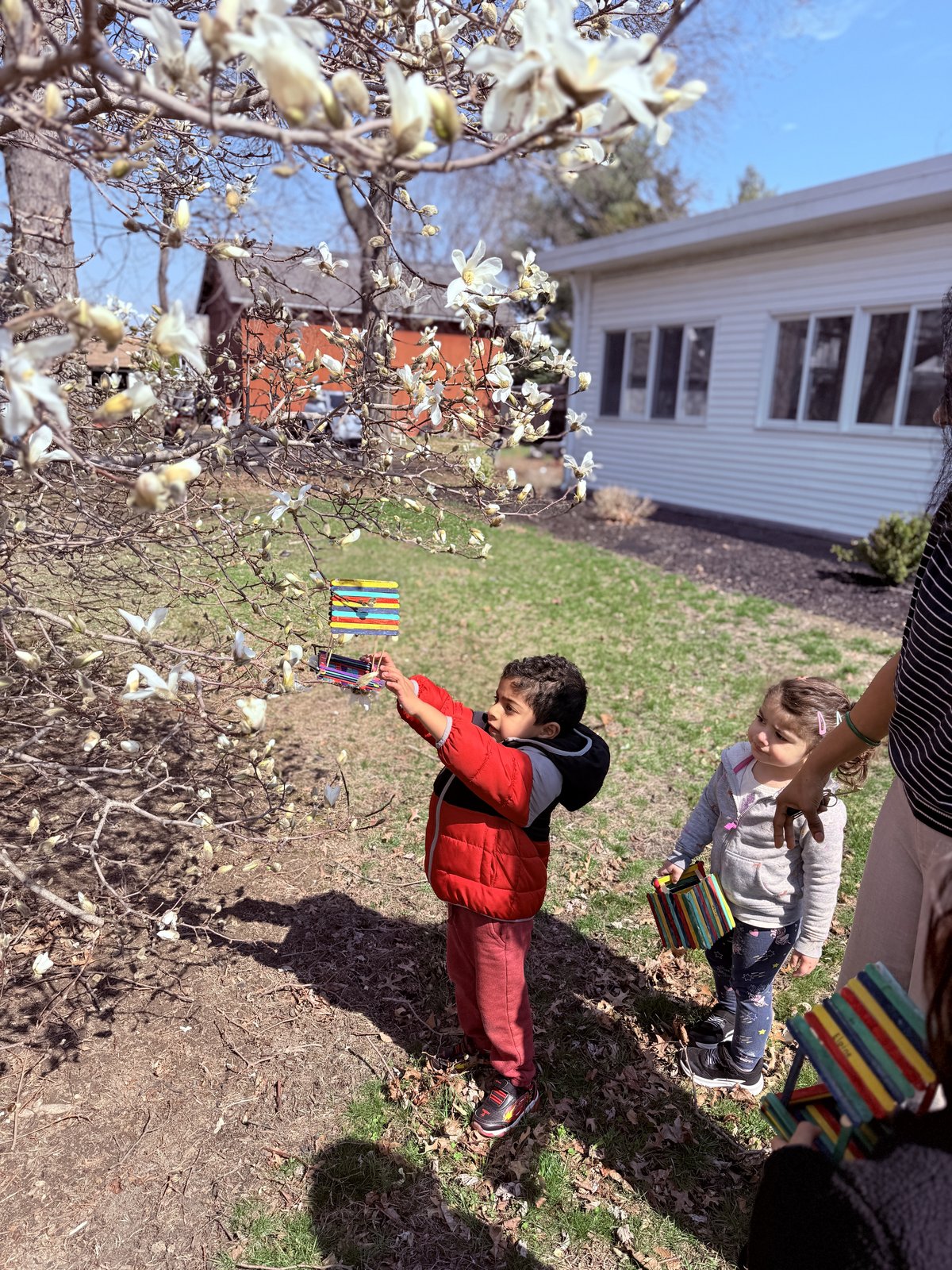 Student carefully placing Montessori bead chain on mat