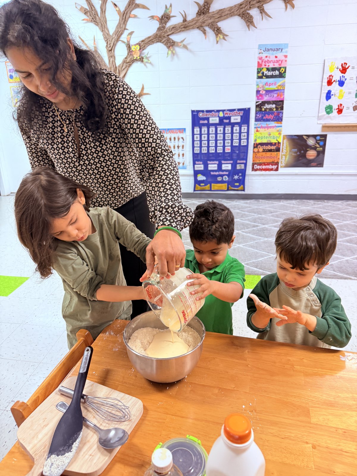 Student carefully measuring in a Montessori science activity