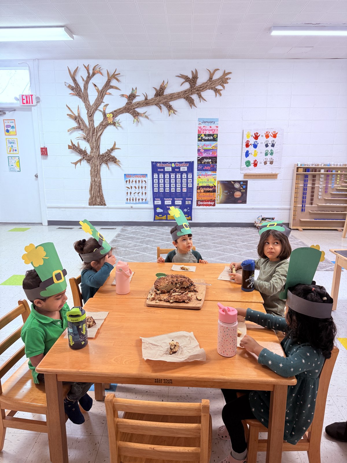 Child carefully sorting shapes and colors on a floor mat