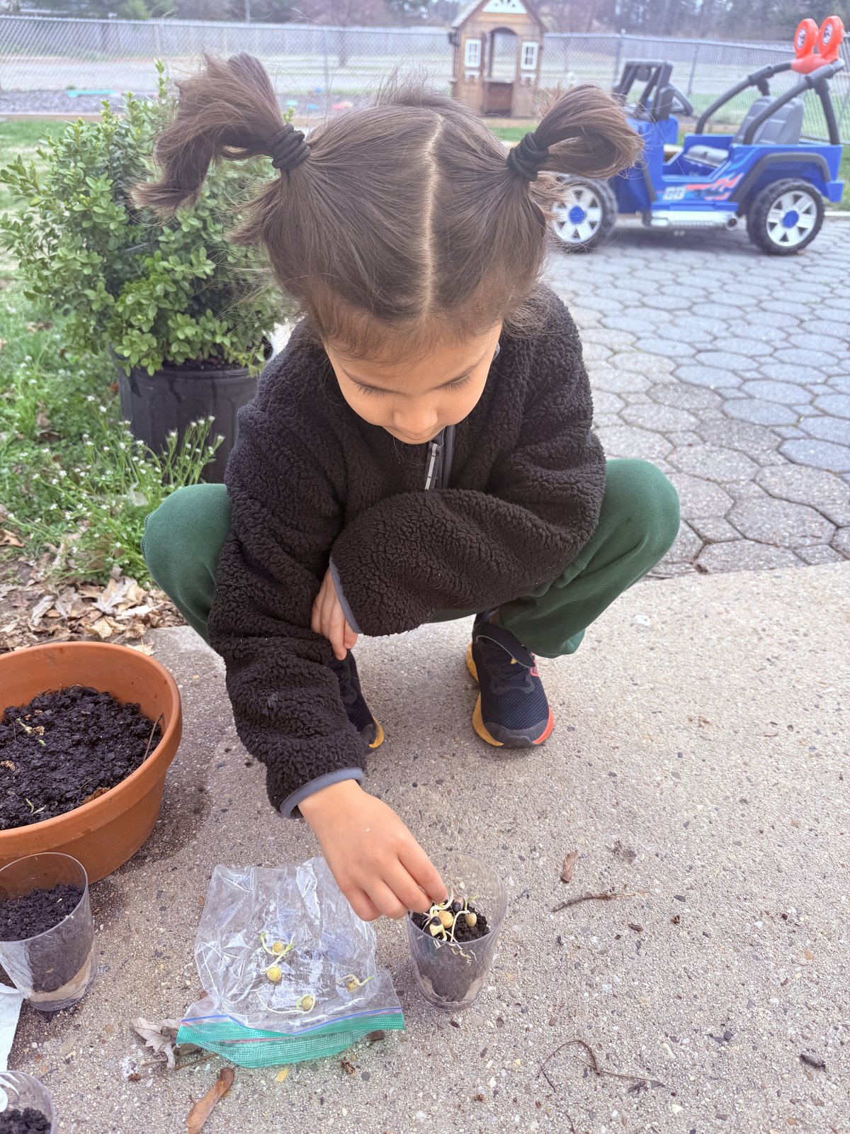 Child planting seeds in an outdoor nature and gardening activity