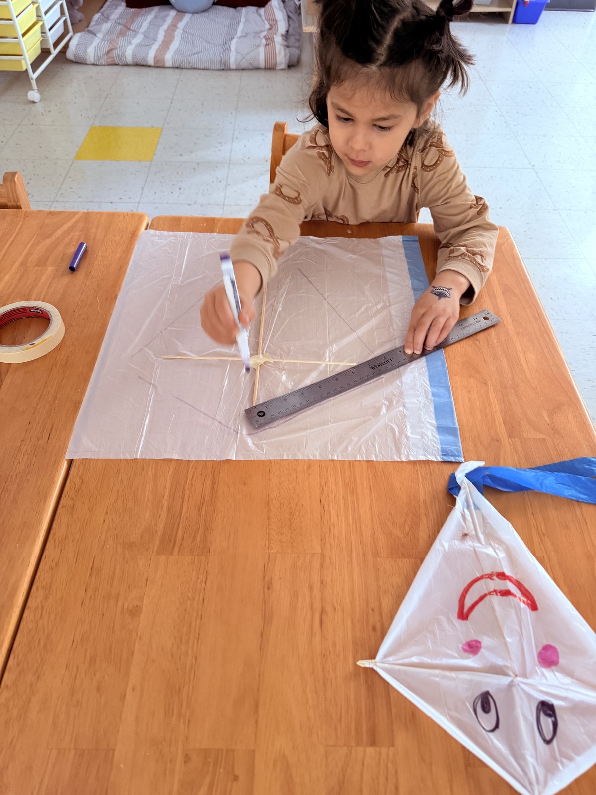 Child carefully rolling out dough in a cooking practical life activity