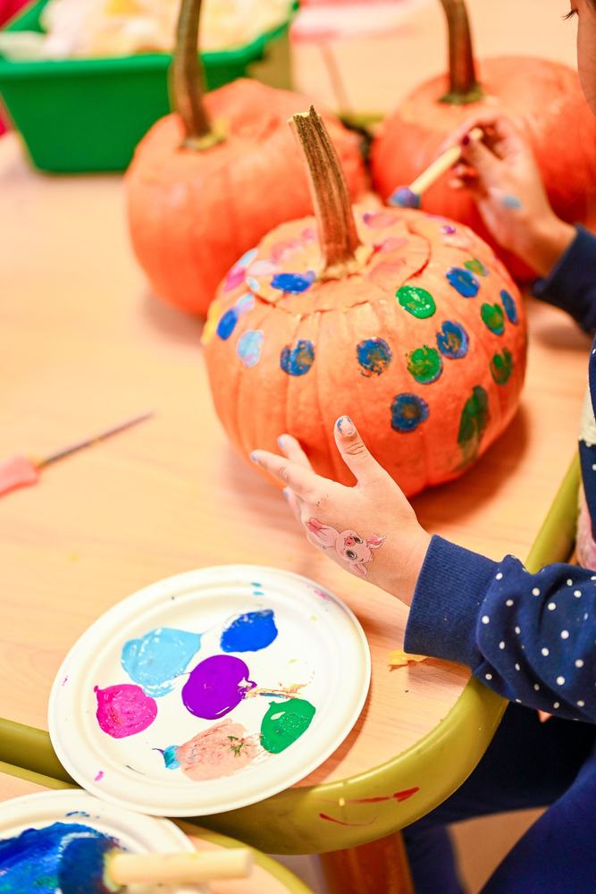 A decorated pumpkin with a paint palette
